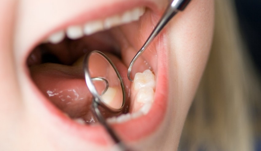 A child's mouth with a stethoscope in it.