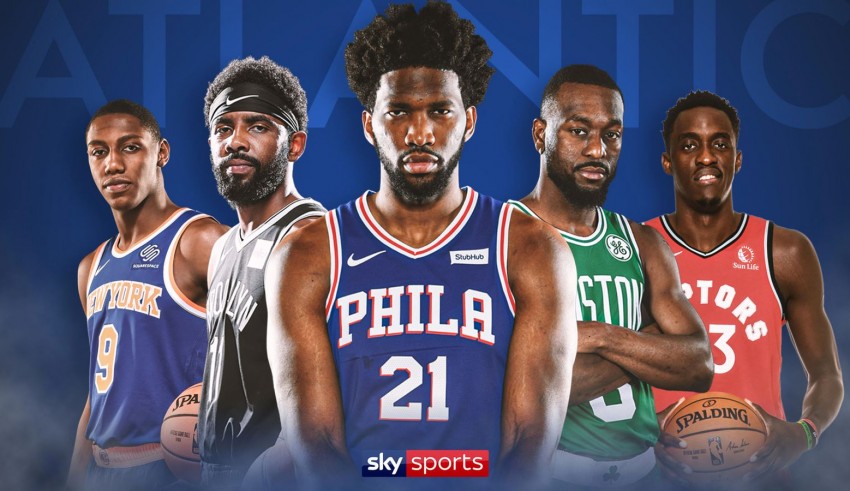 A group of nba players standing in front of a blue background.