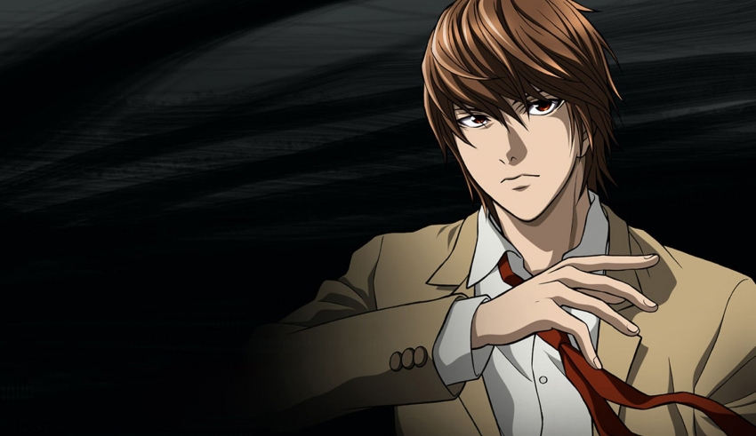 A man in a suit is holding a tie.