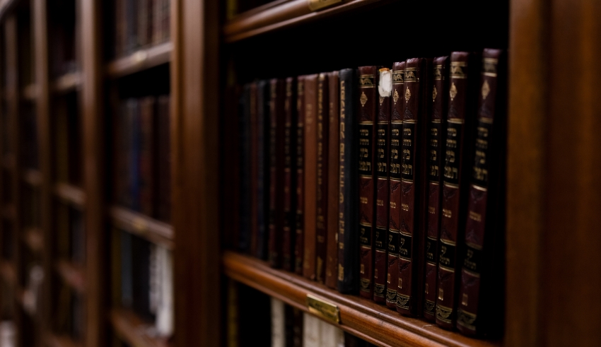 A row of books on a shelf in a library.