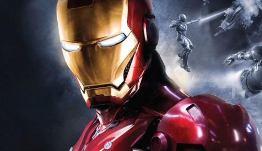 The iron man is standing in front of a group of people.