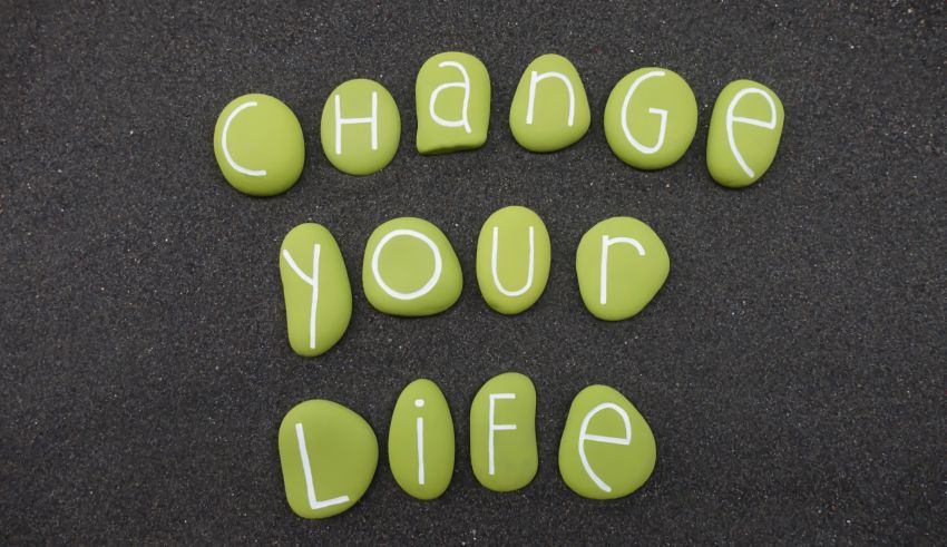 Change your life spelled out in green stones.