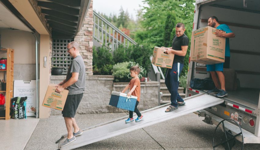 A group of people loading boxes into a moving truck.