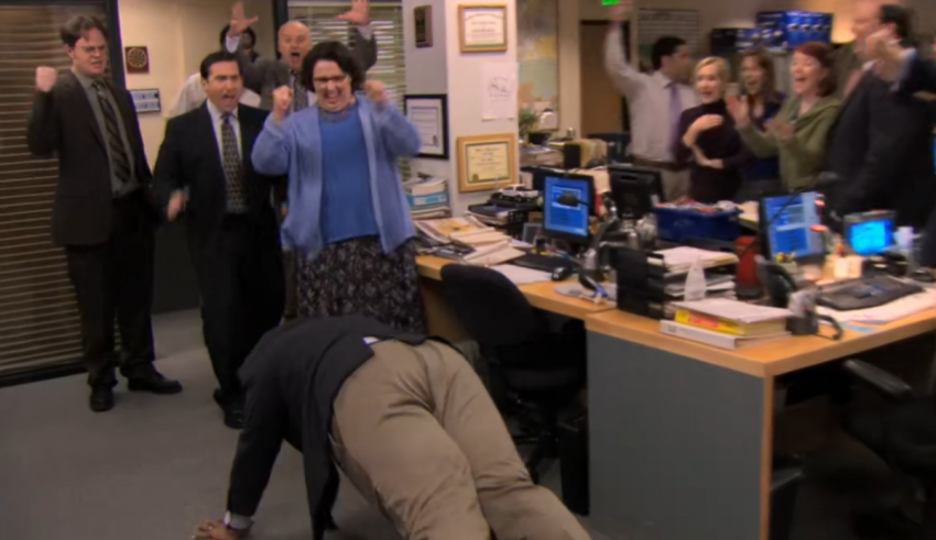 A group of people in an office laying on the floor.
