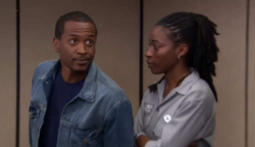 A man and woman standing next to each other in a room.