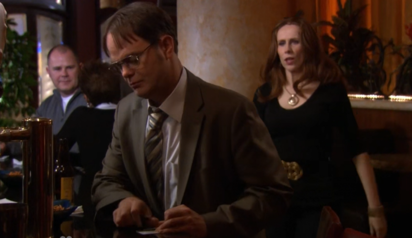 A man and a woman standing at a bar.