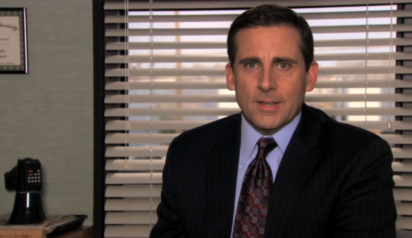 A man in a suit and tie sitting in an office.