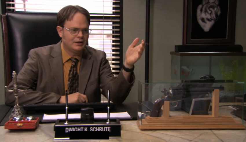 A man in a suit sitting at a desk.