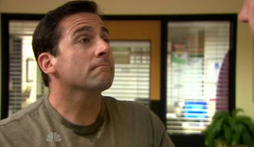 A man is talking to another man in an office.