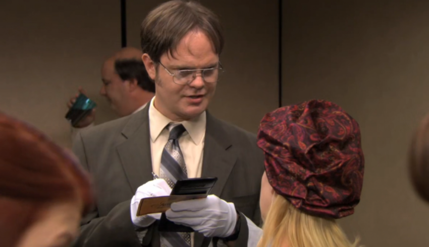 A man in a suit and tie is talking to a woman.