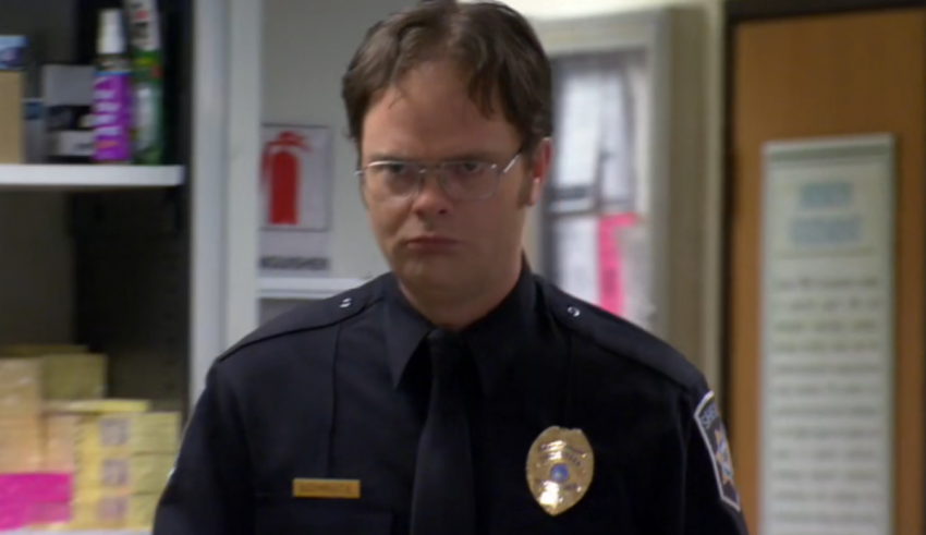 A man in a police uniform standing in a room.