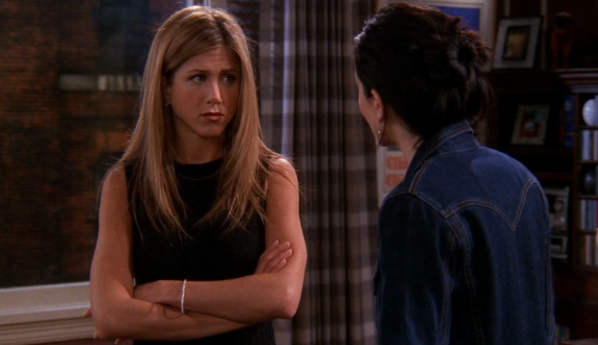 Two women standing next to each other in a living room.