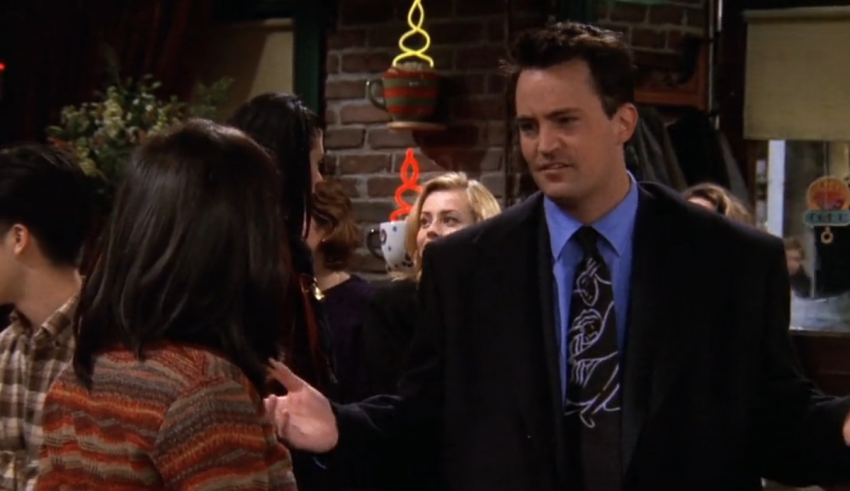 A man is talking to a woman in a bar.
