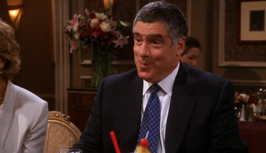 A man and woman sitting at a table with drinks.