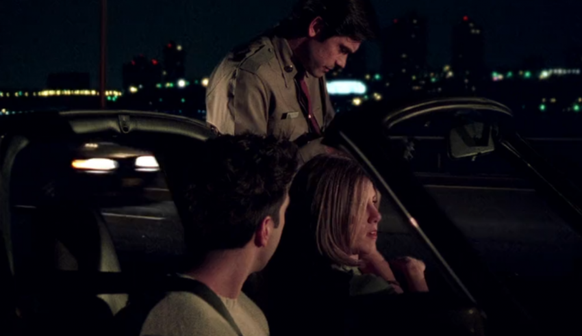 A man and a woman in a car at night.