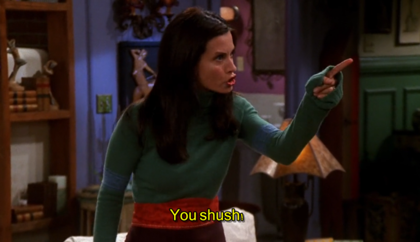 A woman in a green shirt is pointing at something.