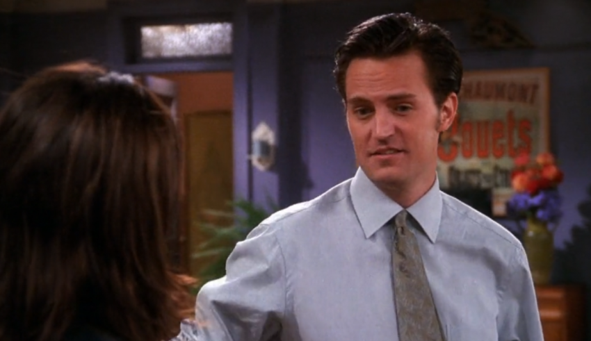 A man is talking to a woman in a room.