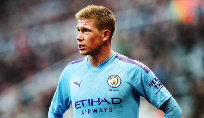 A man in a blue shirt is standing on the field.
