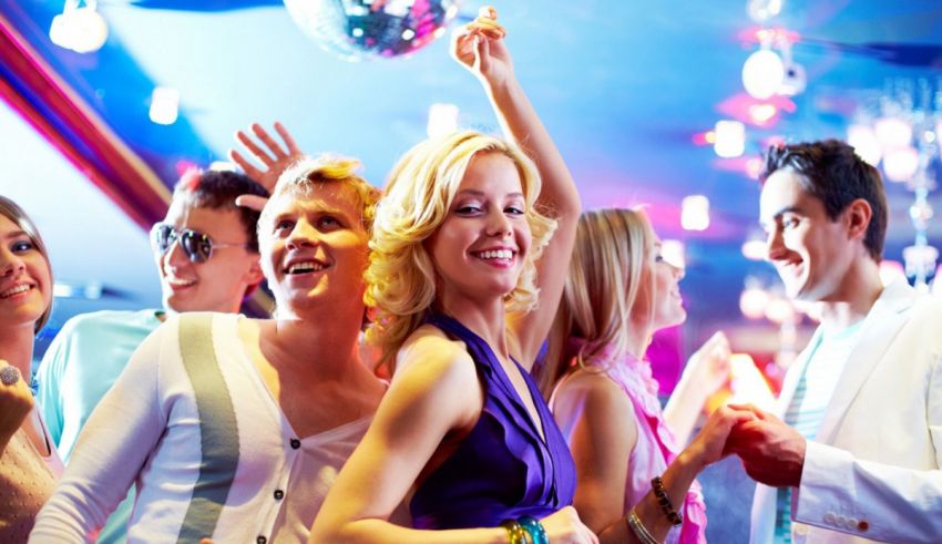 A group of people dancing in a club.