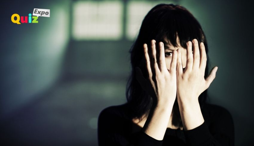 A woman covering her face with her hands.