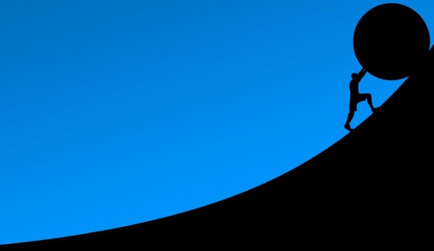 A silhouette of a man climbing a mountain.