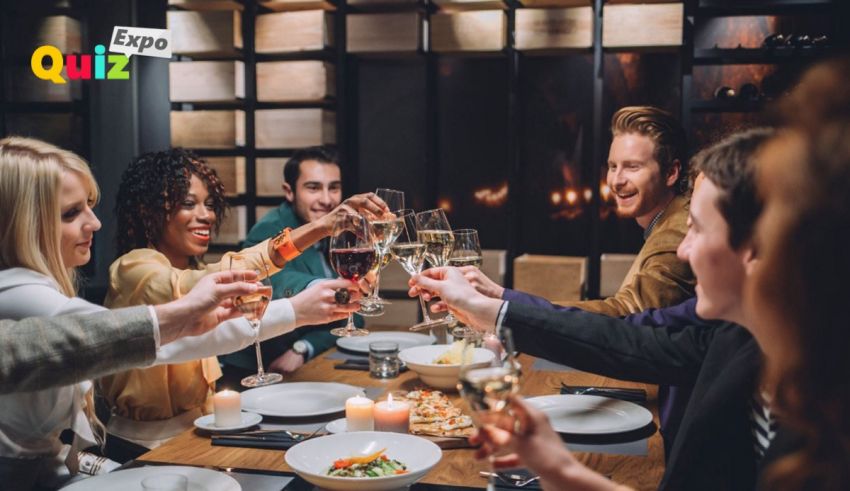 A group of people toasting wine glasses at a dinner table.