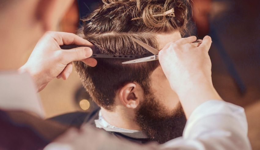 A man is getting his hair cut by a barber.