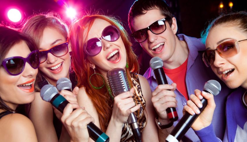 A group of people singing with microphones at a party.