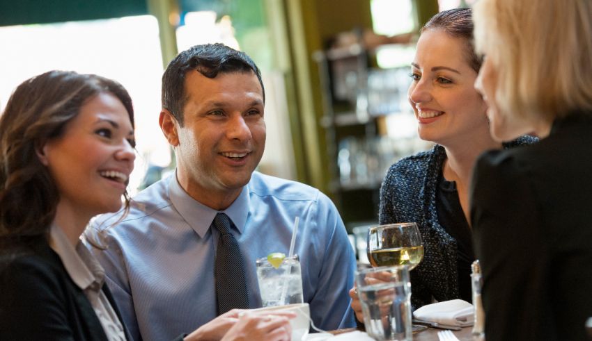 A group of business people sitting around a table.