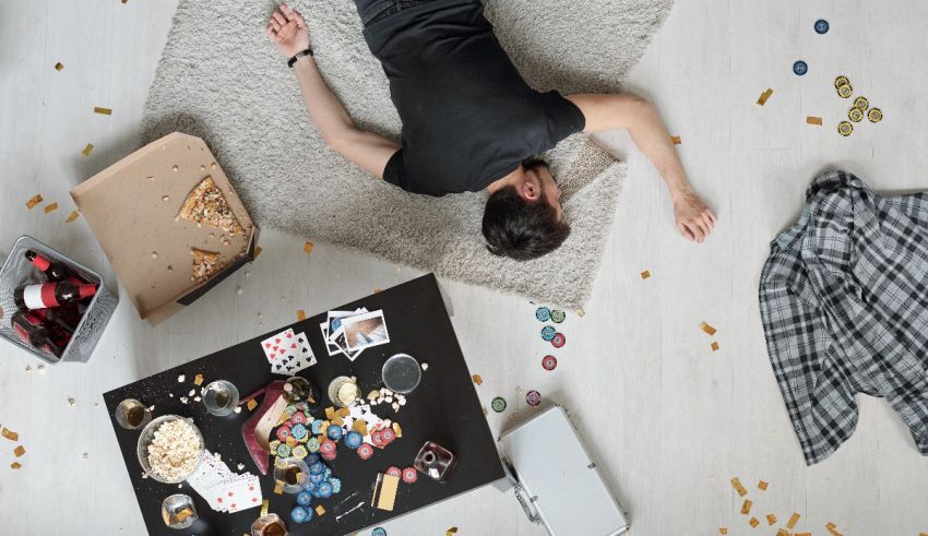 A man laying on the floor with a lot of confetti around him.