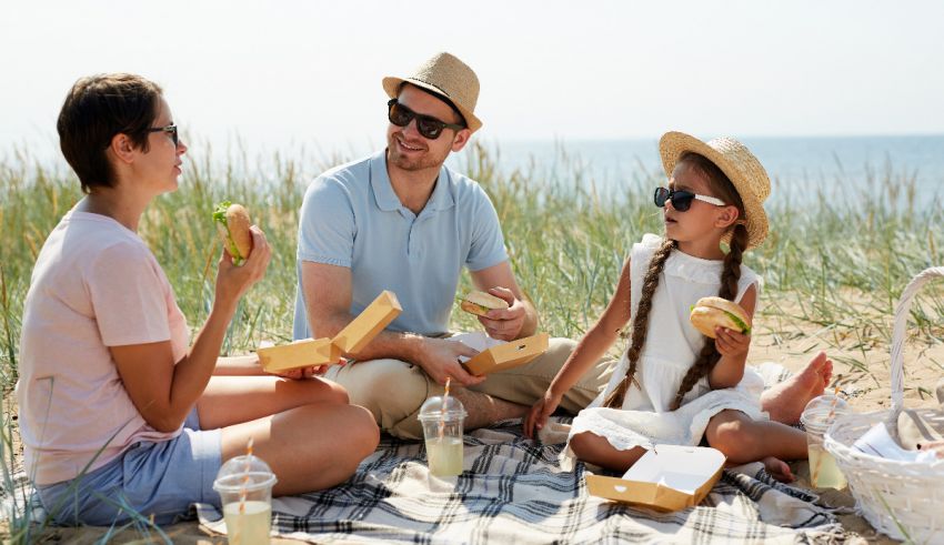 A family having a picnic on the beach.