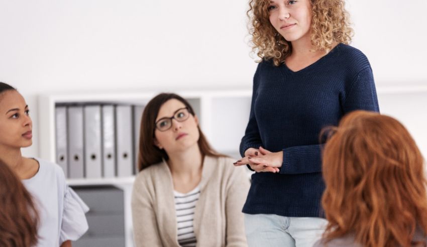 A woman is talking to a group of people in an office.