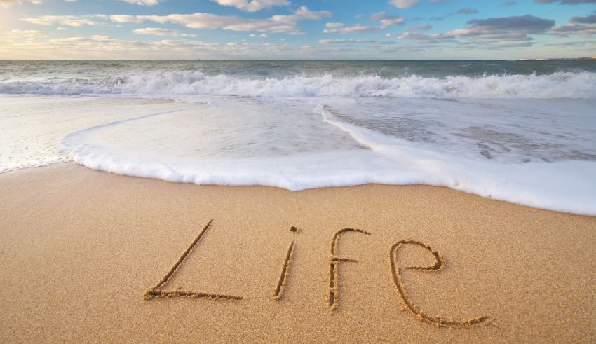 The word life written in the sand on a beach.