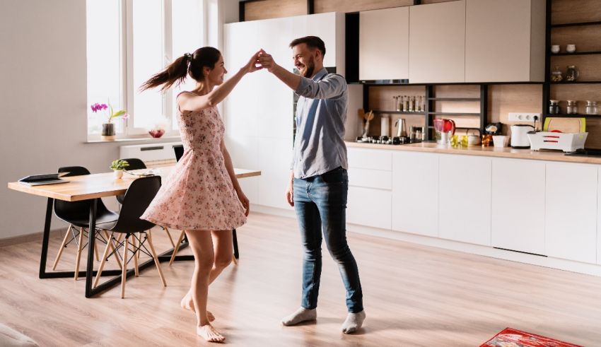 Young couple dancing in the kitchen.