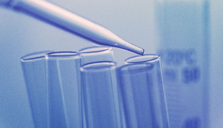 A syringe is being inserted into a test tube.