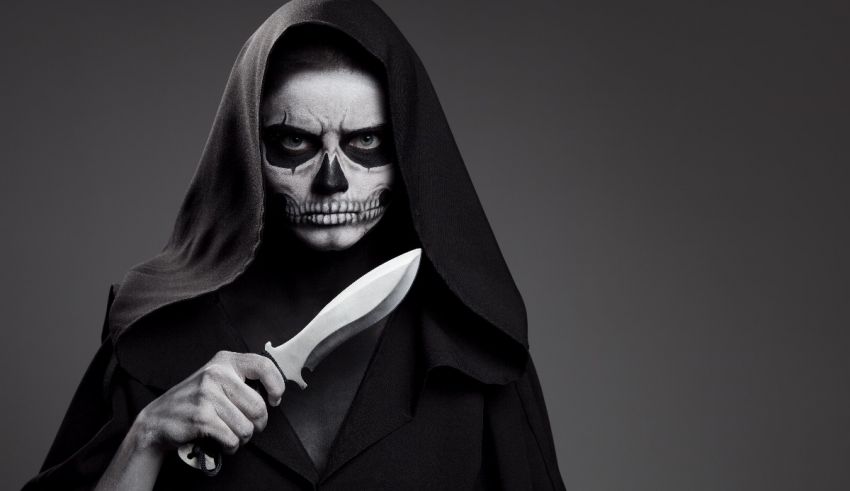 A skeleton woman holding a knife on a gray background.
