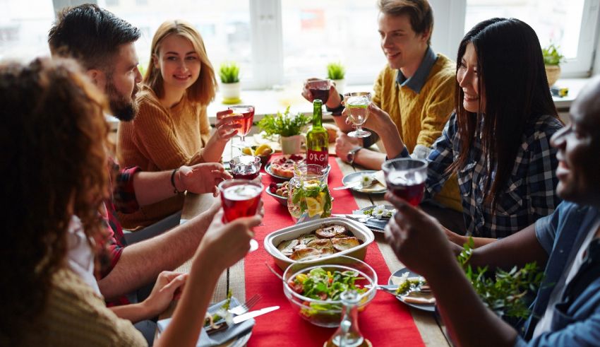 A group of people toasting at a dinner table.