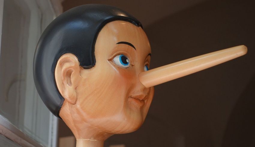 A wooden statue of a man with a long nose.