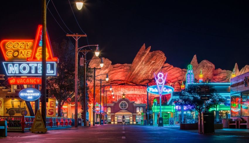 Disneyland at night with neon signs.