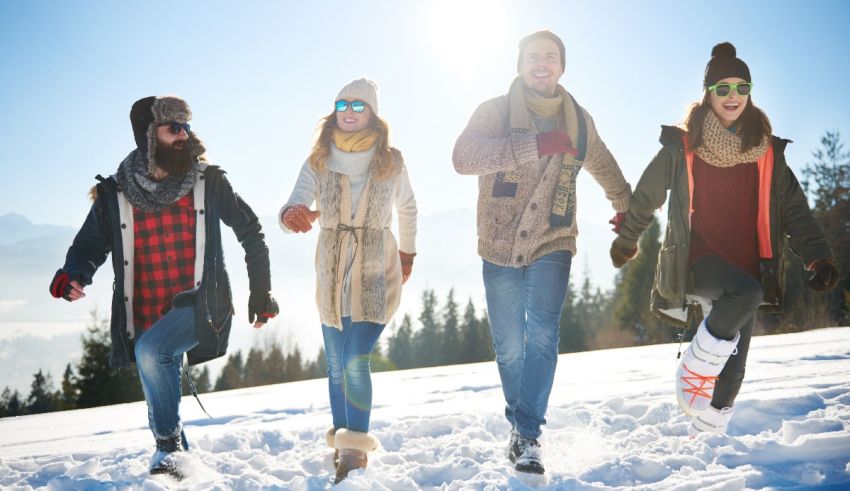 A group of people are walking in the snow on a sunny day.