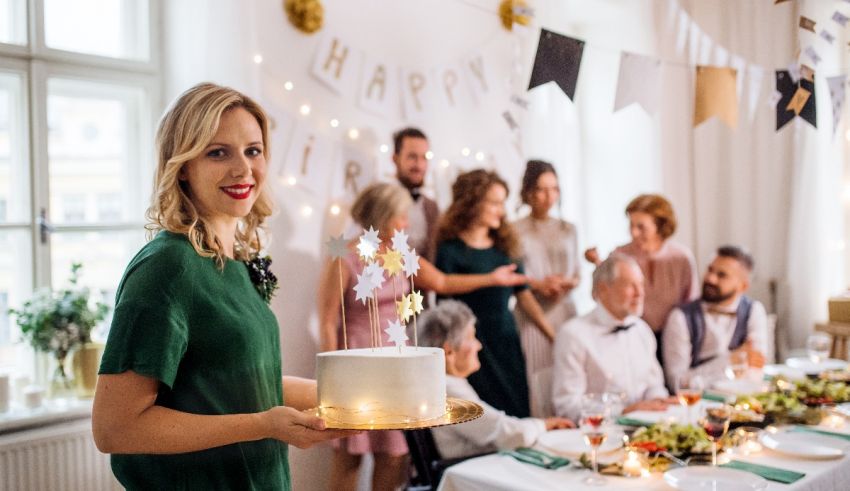 A woman holding a cake in front of a group of people.