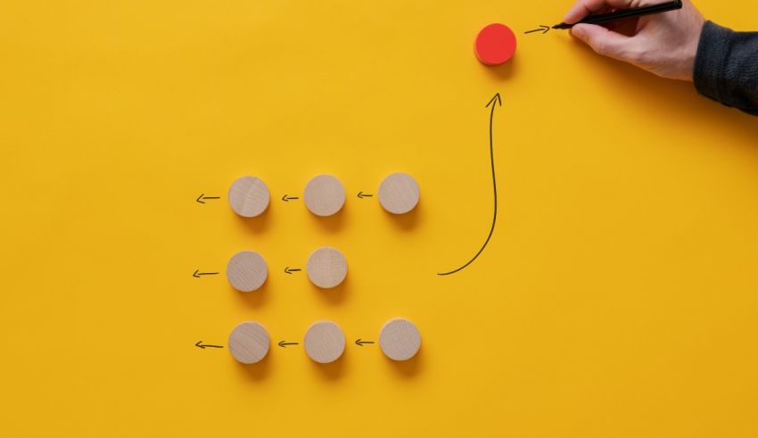A person is drawing a path on a yellow background.