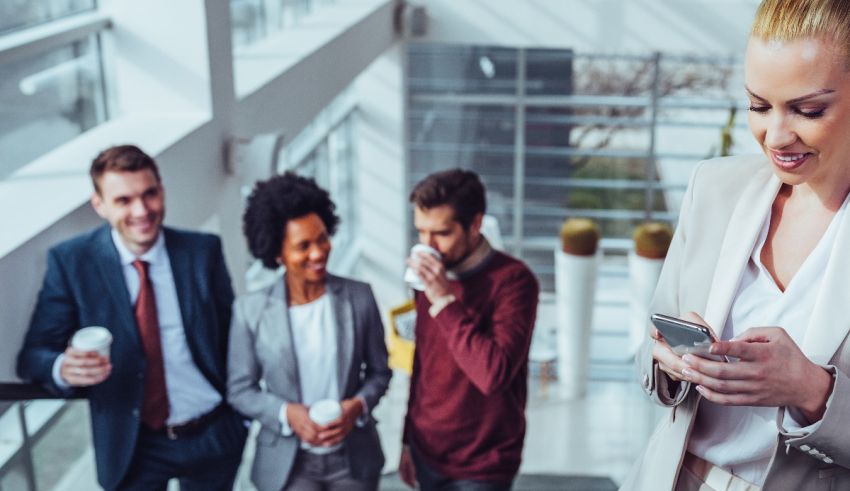 A group of business people looking at their phones.