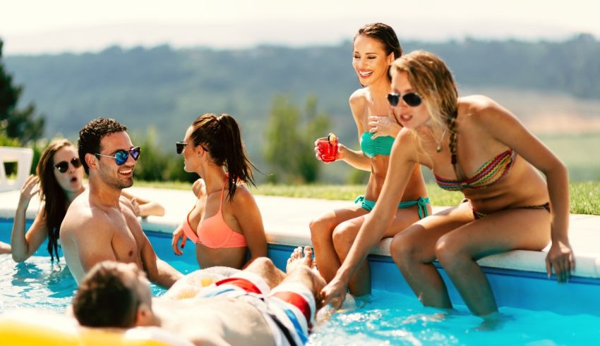 A group of people enjoying themselves in a swimming pool.