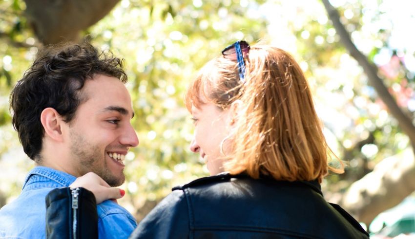 A man and woman are looking at each other in the park.
