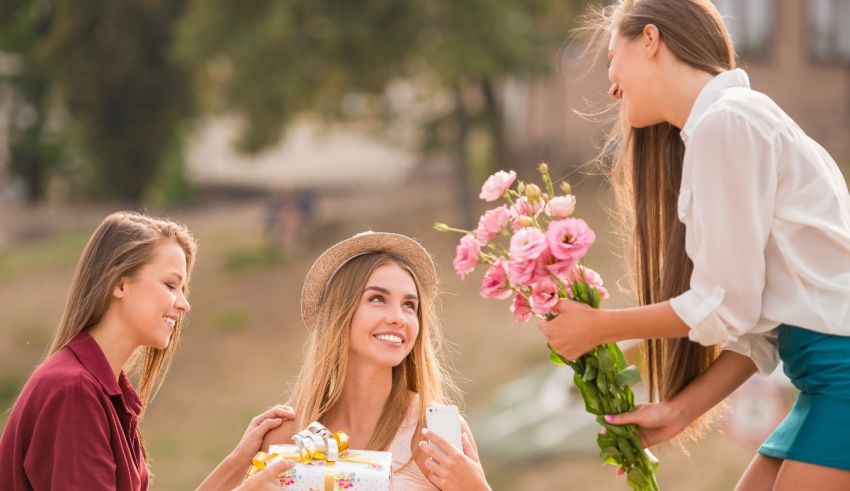 A group of girls are holding flowers and giving them to each other.