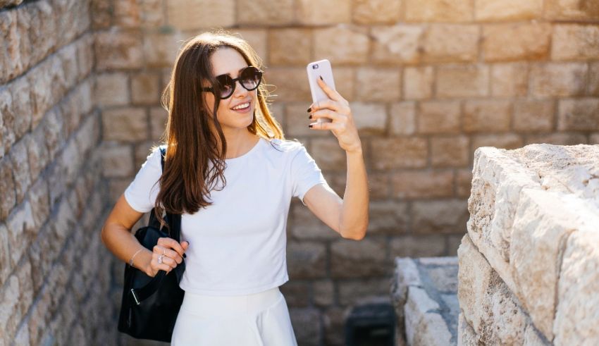 A woman is taking a selfie with her cell phone.
