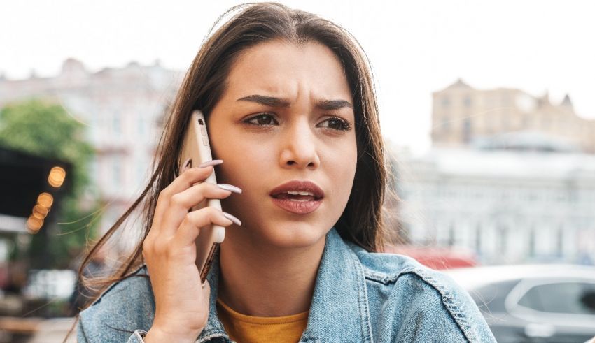 A woman talking on a cell phone in a city.