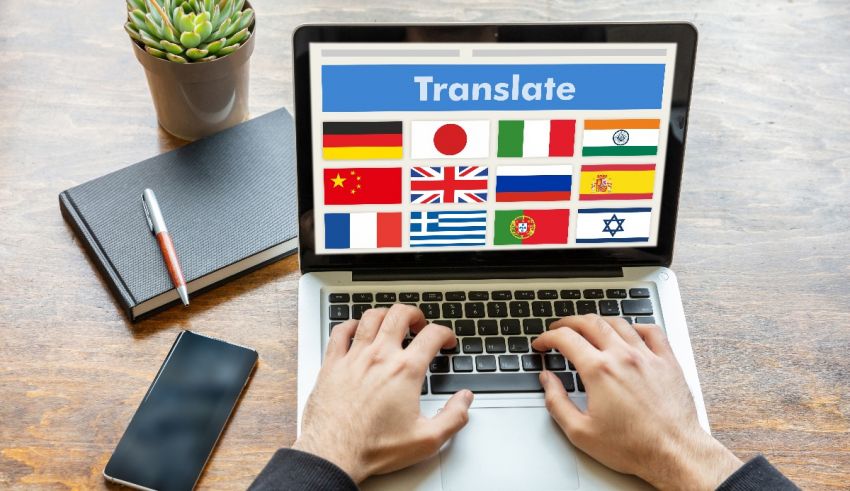 A man typing on a laptop with flags on the screen.