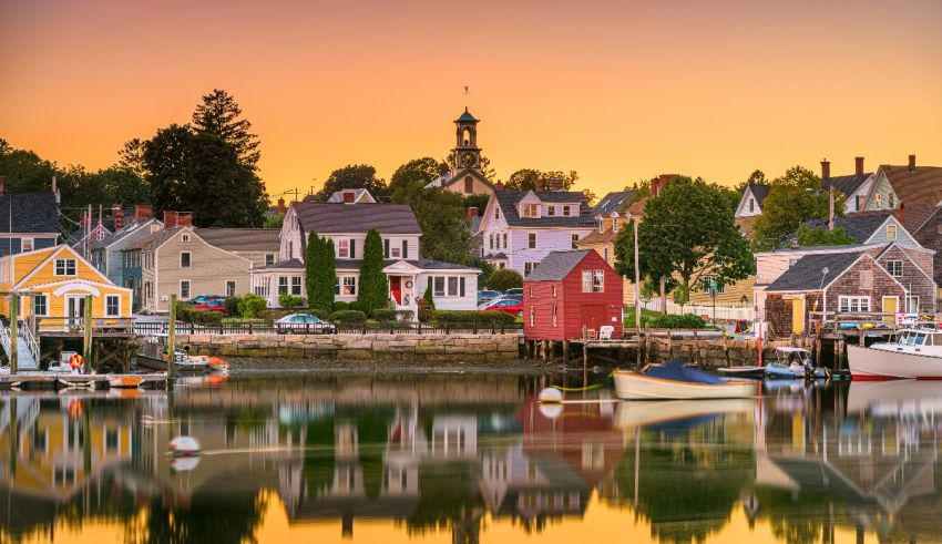 A harbor with boats and houses in the background.